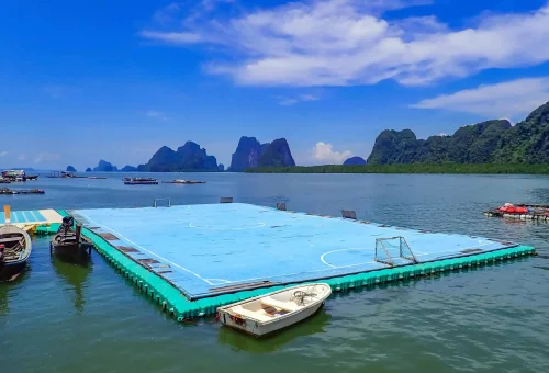 Floating football field at Koh Panyee village, surrounded by wooden walkways and emerald waters — a unique highlight on the early departure James Bond Island Tour.