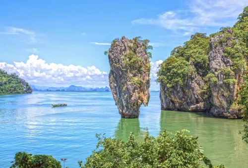Iconic limestone karst formations rising from the emerald waters of Phang Nga Bay, captured during the early departure James Bond Island Tour.