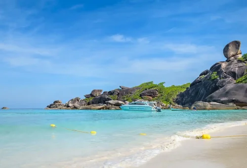 Breathtaking view of Donald Duck Bay in the Similan Islands with clear turquoise water, white sand beach, and dramatic granite boulders.