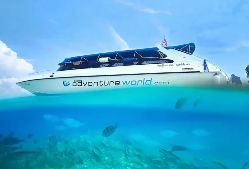 Speedboat approaching the shores of Koh Rok with clear turquoise water, white sandy beaches, and lush island scenery