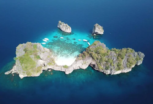 Full aerial view of Koh Haa’s cluster of limestone islets surrounded by turquoise waters, coral reefs, and a hidden lagoon