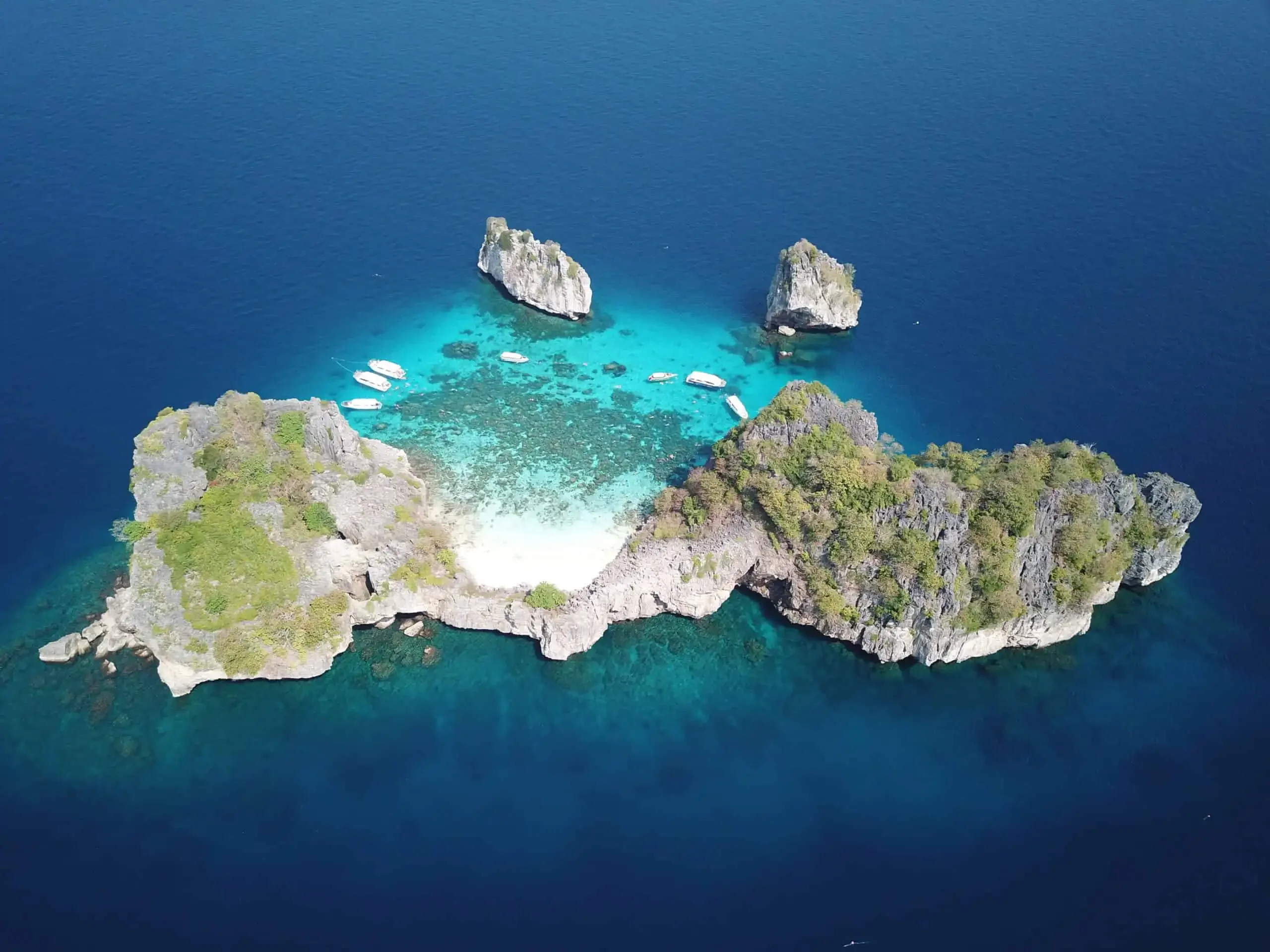 Full aerial view of Koh Haa’s cluster of limestone islets surrounded by turquoise waters, coral reefs, and a hidden lagoon