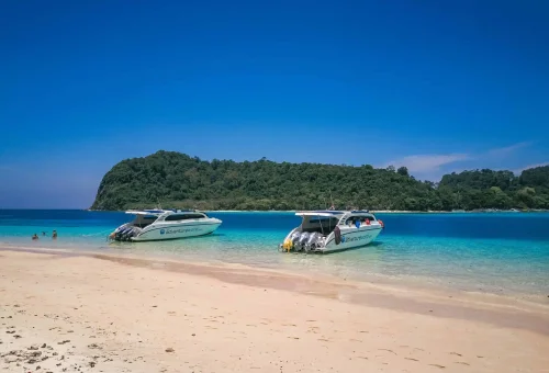 Peaceful view of Koh Rok’s empty white sand beach with turquoise waters and untouched tropical landscape