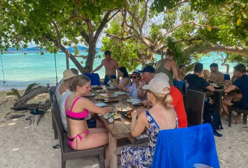 Traditional Thai lunch served on the beach at Koh Kradan, with views of white sand and turquoise sea