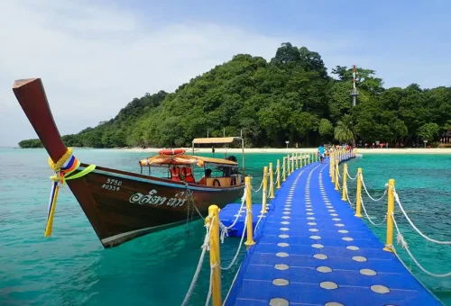 Stunning view of Koh Rok with turquoise waters, white sandy beaches, and lush tropical landscape