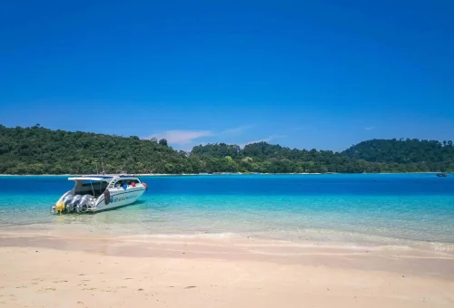 Secluded beach on Koh Rok with untouched white sand, gentle waves, and no people in sight