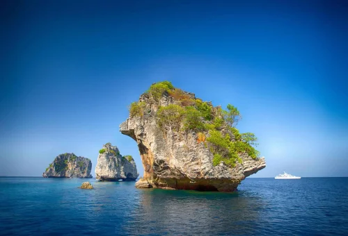 Scenic view of Koh Haa’s limestone cliffs rising from turquoise waters with a small beach nestled between the islands