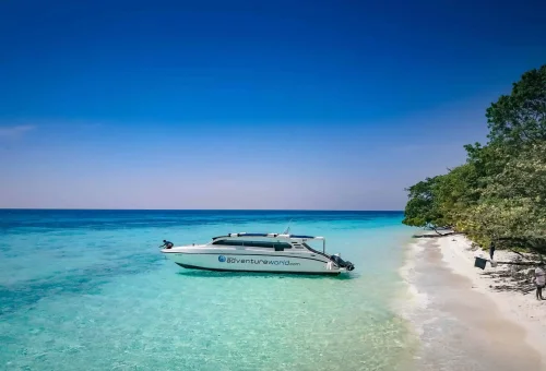 White sandy beach on Koh Rok with crystal-clear turquoise waters and a peaceful, tropical island backdrop