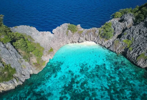 Aerial view of Koh Haa’s limestone islets and emerald lagoon surrounded by crystal-clear blue sea