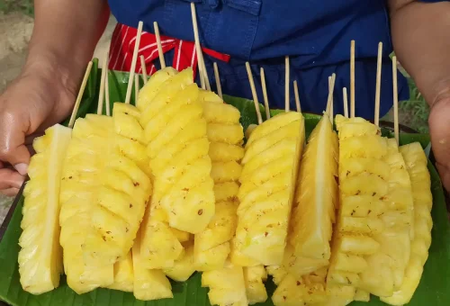 Fresh pineapples growing at Old Phuket Farm in Phuket, surrounded by tropical greenery and traditional farm elements