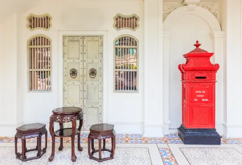 Sino-Portuguese style street scene at Old Phuket Farm, featuring colorful colonial facades and vintage-style architecture