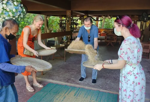 Scenic view of Old Phuket Farm with traditional Thai wooden houses, coconut trees, and a peaceful rural landscape