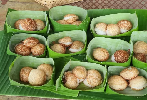 Traditional Thai lunch served on a wooden table at Old Phuket Farm, featuring local dishes in a rustic setting