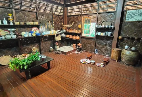 "Visitors exploring traditional Thai farming tools and techniques at Phuket Old Farm, surrounded by nature