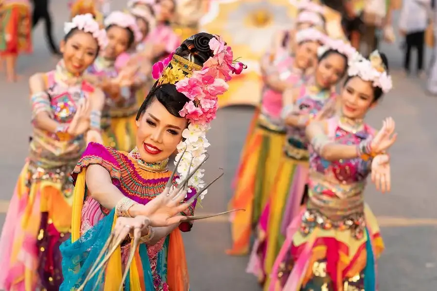 Travelers learning about traditional Thai practices and daily life at a cultural stop in Phuket