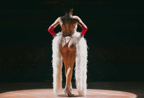 Simon Cabaret Phuket performer on stage in a sparkling gown, framed by dramatic lighting and elegant set design.