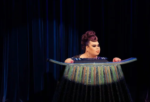 Simon Cabaret Phuket grand stage finale with performers in elaborate costumes, framed by vibrant lights and decor.