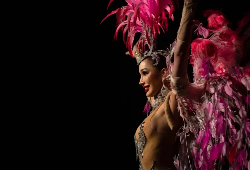 Simon Cabaret Phuket performer mid-performance in a dramatic outfit, surrounded by theatrical lighting and stage effects.