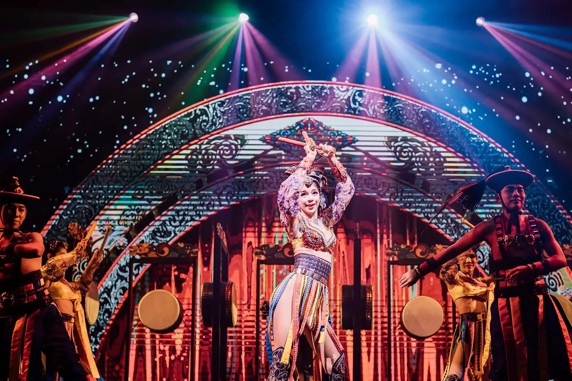 Simon Cabaret Phuket stage scene featuring a vibrant ensemble of performers in themed, colorful costumes.