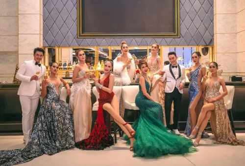 Simon Cabaret Phuket performer in an elegant costume, gracefully posing under spotlight on a dazzling stage.