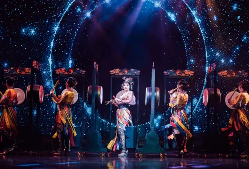 Simon Cabaret Phuket ensemble performing on a vibrant stage with colorful costumes and synchronized choreography.