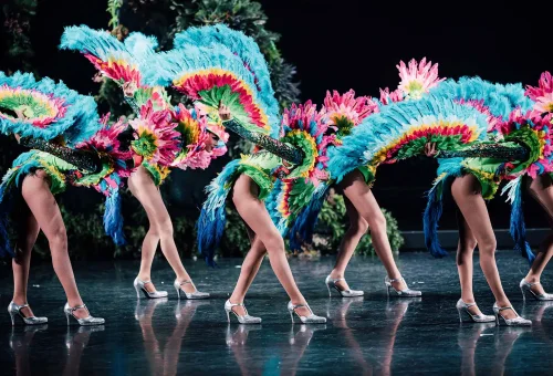Simon Cabaret Phuket performer on stage in a flowing costume with vibrant lighting and an elegant backdrop.