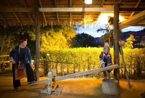 Elegant scene from Siam Niramit Phuket showcasing performers in ceremonial Thai costumes against a temple-inspired backdrop.