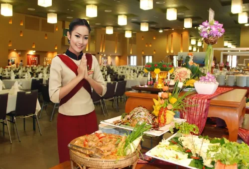 Scene from Siam Niramit Phuket showing traditional Thai village life with performers reenacting daily cultural activities on stage.