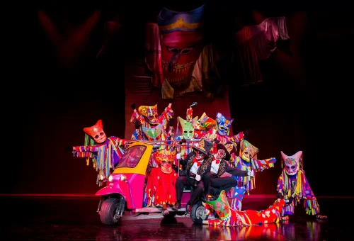 Elephants and performers in a cultural procession with lights and music at Phuket FantaSea