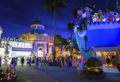 Guests entering the grand, illuminated palace gate of Phuket FantaSea at night