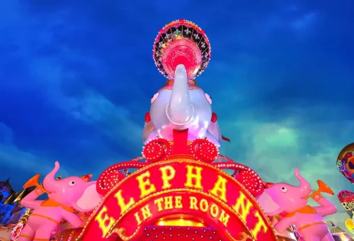 Colorful illuminated trees and whimsical light displays glowing at night in Carnival Magic Phuket