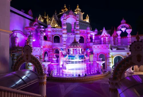 Colorful light arches creating a glowing pathway at night in Carnival Magic Phuket
