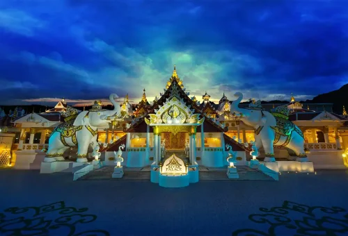Guests taking photos in front of a grand illuminated display at Carnival Magic Phuket