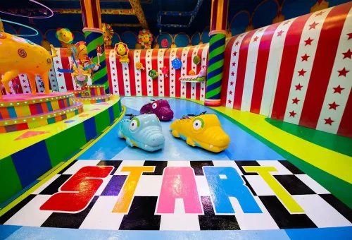 Brightly lit garden with colorful lanterns and floral light displays at Carnival Magic Phuket