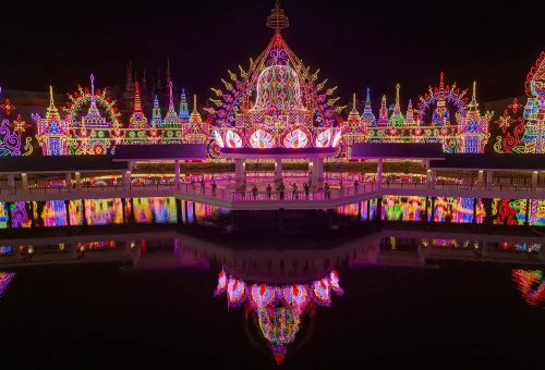Colorful illuminated castle structure surrounded by festive lights at Carnival Magic Phuket