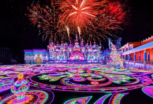 Guests enjoying illuminated walkways and colorful displays at night in Carnival Magic Phuket