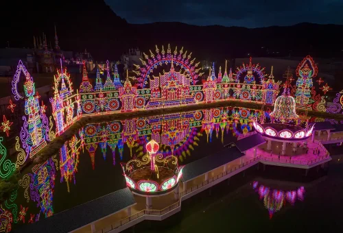 Night view of Carnival Magic Phuket with glowing decorations, light displays, and festive atmosphere