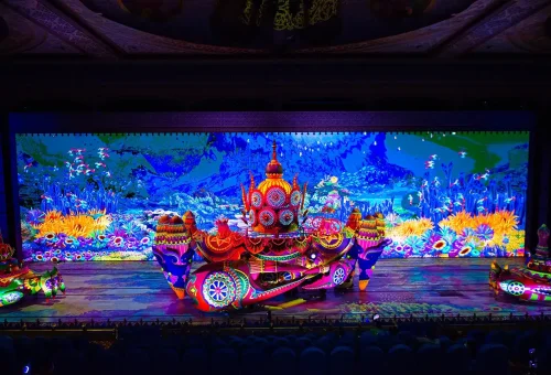 Visitors strolling through a garden of lights and illuminated sculptures at Carnival Magic Phuket