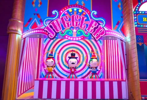 Colorful performers dancing in sync on a vibrant stage at Carnival Magic Phuket night show