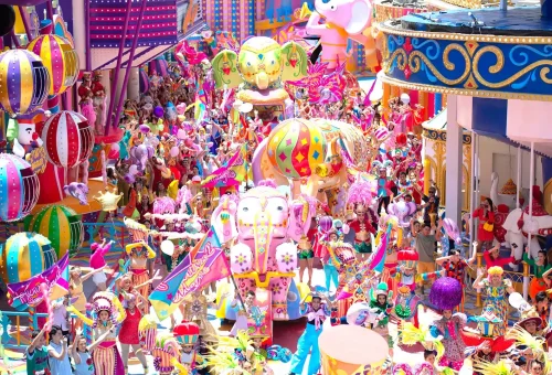 Visitors taking photos at a brightly lit entrance with festive decorations at Carnival Magic Phuket