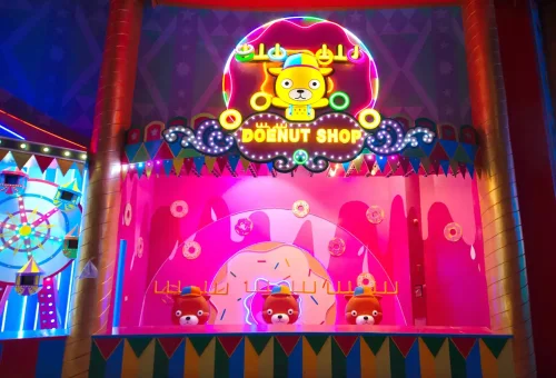 Spectacular nighttime parade float glowing with lights and colors at Carnival Magic Phuket