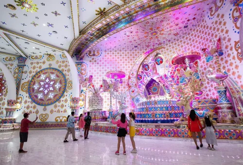 Dazzling float with glowing decorations and performers during the night parade at Carnival Magic Phuket