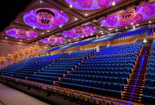 Illuminated parade floats with vibrant lights and performers at Carnival Magic Phuket