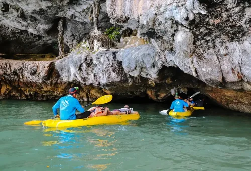 Twilight canoeing at Hong Island with glowing water and limestone cliffs under the evening sky.