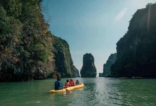 Tourists kayaking through a limestone cave at Hong Island, Phang Nga Bay