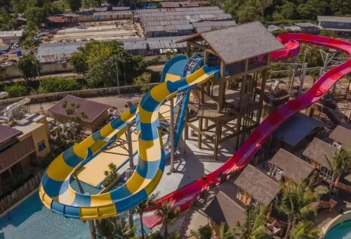 Panoramic view of Andamanda Phuket’s water slide zone, filled with colorful, looping slides and excited guests enjoying the ride.