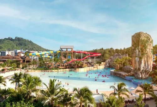 A wide-angle view of Andamanda Phuket Waterpark showcasing themed zones, giant slides, pools, and tropical surroundings, creating a vibrant entertainment world.