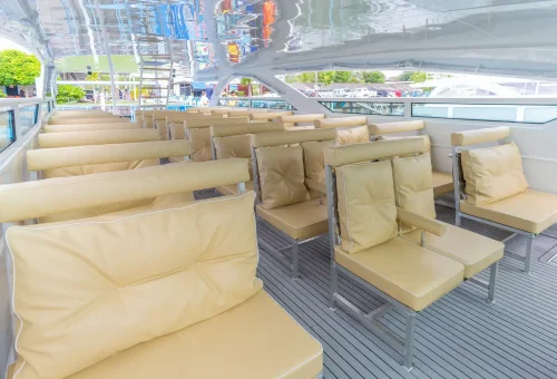 Guests relaxing on a modern speed catamaran with cushioned seating and open-air views during a scenic ride to the Phi Phi Islands.