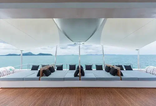 Elegant seating area with plush cushions and ambient lighting on a luxury catamaran cruising near James Bond Island, offering a premium onboard experience.