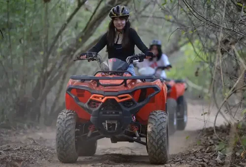 Lady riding an ATV through tropical jungle trails at Phuket ATV Adventure, featured by Phuket Travel Store